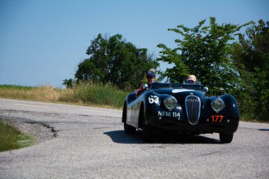 URBINO - ITALY - JUN 16 - 2022 : JAGUAR XK120 OTS ROADSTER 1950 on an old racing car in rally Mille Miglia 2022 the famous italian historical race (1927-1957