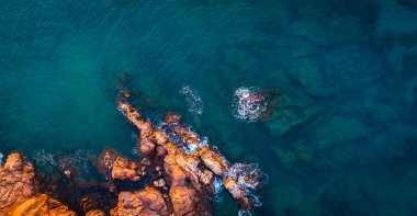 Turuncu kayalar ve mavi denizle yaz arkaplanı. Okyanus kıyısının sanatsal arka planı. Yaz kavramsal geçmişi. Costa Brava, Akdeniz, yaz tatili, plaj.