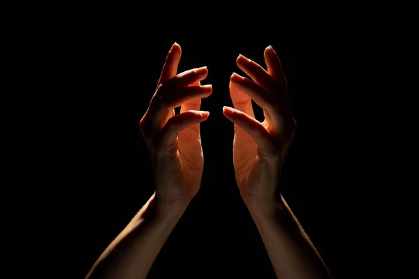 Gör magi med händerna, eller be att ljuset faller ovanifrån. Utstrålning mellan handflatorna. — Stockfoto