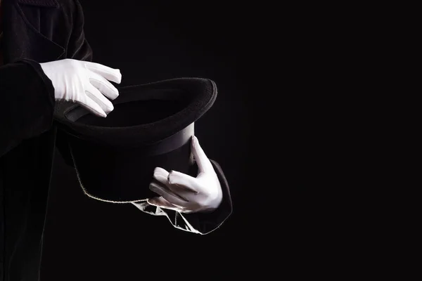 Handgester. Showman visar försvinnande tricks i en hatt, vita handskar och svart hög hatt, — Stockfoto