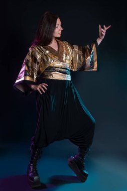 Şık ve cüretkar bir görüntü, fütüristik moda. Çok kültürlü giyinmiş genç bir kadın.