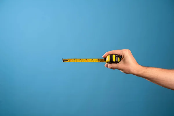 Messen Sie es, ein gelbes Konstruktionsband misst die Länge von etwas. — Stockfoto