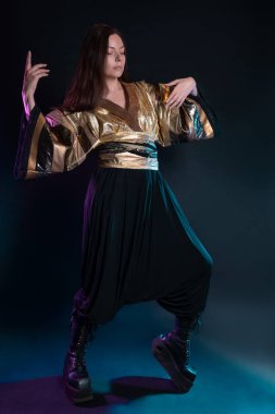 Şık ve cüretkar bir görüntü, fütüristik moda. Çok kültürlü giyinmiş genç bir kadın.