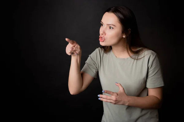 To be indignant and accuse the interlocutor, a young woman argues with the interlocutor by pointing her finger.