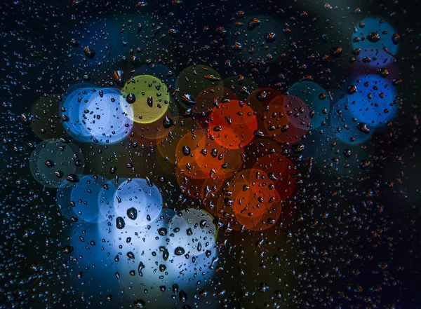 Blurred light with rain drops on the window — Stock Photo, Image