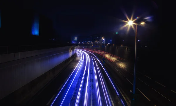 Light trail view at a busy highway — Stock Photo, Image