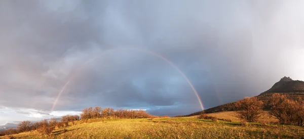 Rainbow over the hill — Stock Photo, Image