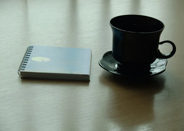 Cup and notepad — Stock Photo, Image