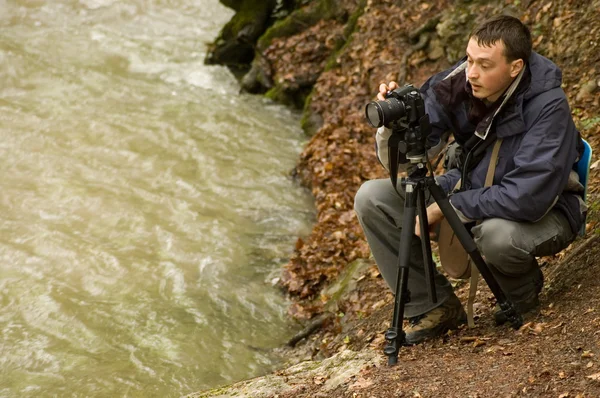 Photographer with camera on tripod Stock Image