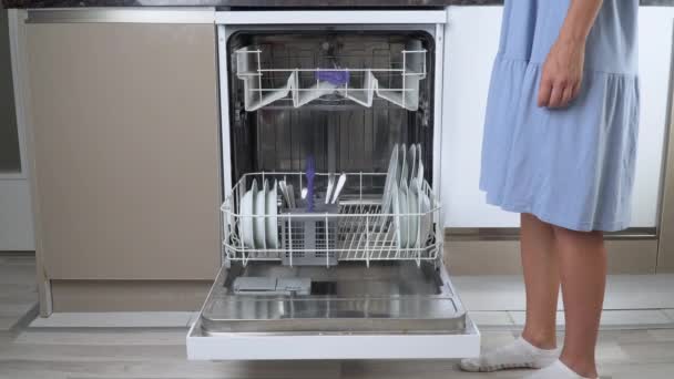 Uma Dona Casa Carrega Uma Máquina Lavar Louça Com Pratos — Vídeo de Stock