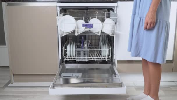 Housewifes Hand Puts Dirty Plates Top Shelf Dishwasher Front View — Stock Video