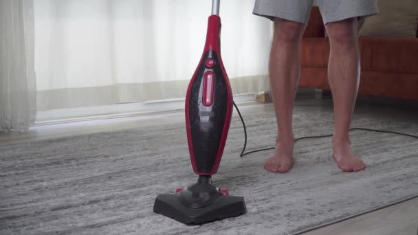 Een Man Stofzuigt Het Tapijt Kamer Hoge Kwaliteit Beeldmateriaal — Stockvideo