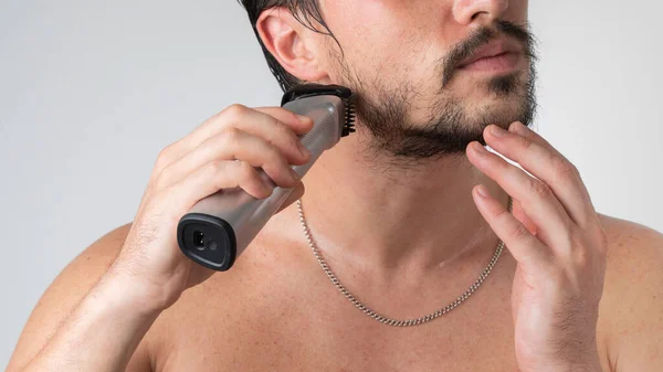 Hombre Con Una Navaja Eléctrica Sus Manos Afeita Barba Cerca — Foto de Stock