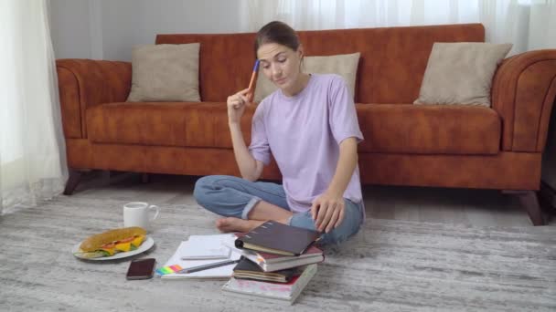 Female Student Studies Home Textbooks Solves Problem Notebook Sitting Floor — Stock Video