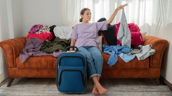 Woman Packs Suitcase Decides What Take Trip Lot Clothes High — Stock Photo, Image