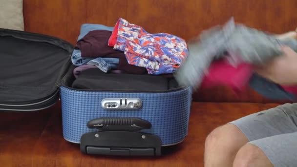 Ein Mann Packt Einen Koffer Verstaut Seine Kleidung Und Schließt — Stockvideo