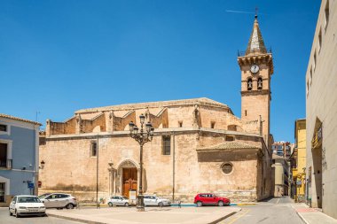 VILLENA,SPAIN - MAY 27,2022 - Bell tower with Church of Saint Jaume in the streets of Villena town. Villena is a city in Spain, in the Valencian Community.
