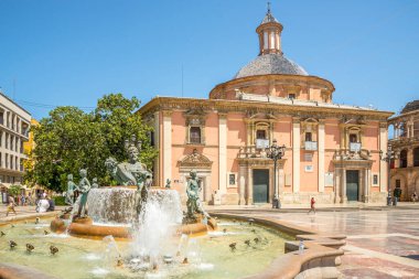 VALENCIA,SPAIN - MAY 28,2022 - View at the Fountain of Turia and Basilica of Our Lady at Virgin square of Valencia. Valencia is also the capital of the province of the same name.