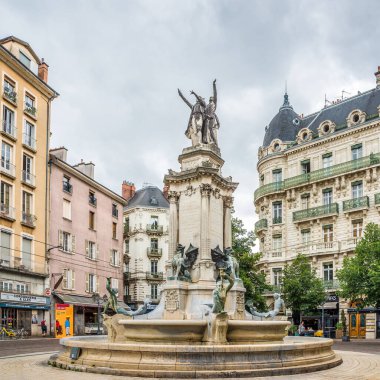 GRENOBLE, FRANCE - JUNE 27,2022 - View at the Foubtain of the Three Orders in the streets of Grenoble. Grenoble is the prefecture and largest city of the Isere department in southeastern France.