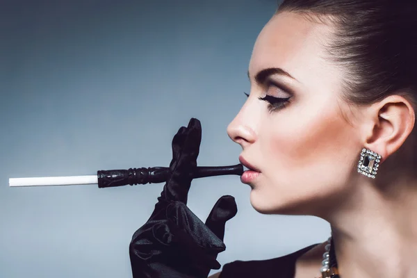 Portrait girl in gloves holding mouthpiece touching lips. Space for your text — Stock Photo, Image