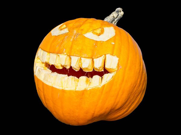 Jack-o-lantern carved pumpkin isolated over the black background