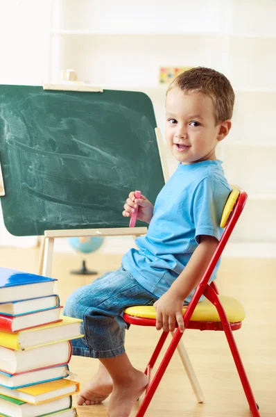 Little schoolboy at the chalkboard