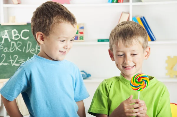 two little boys and one lollipop