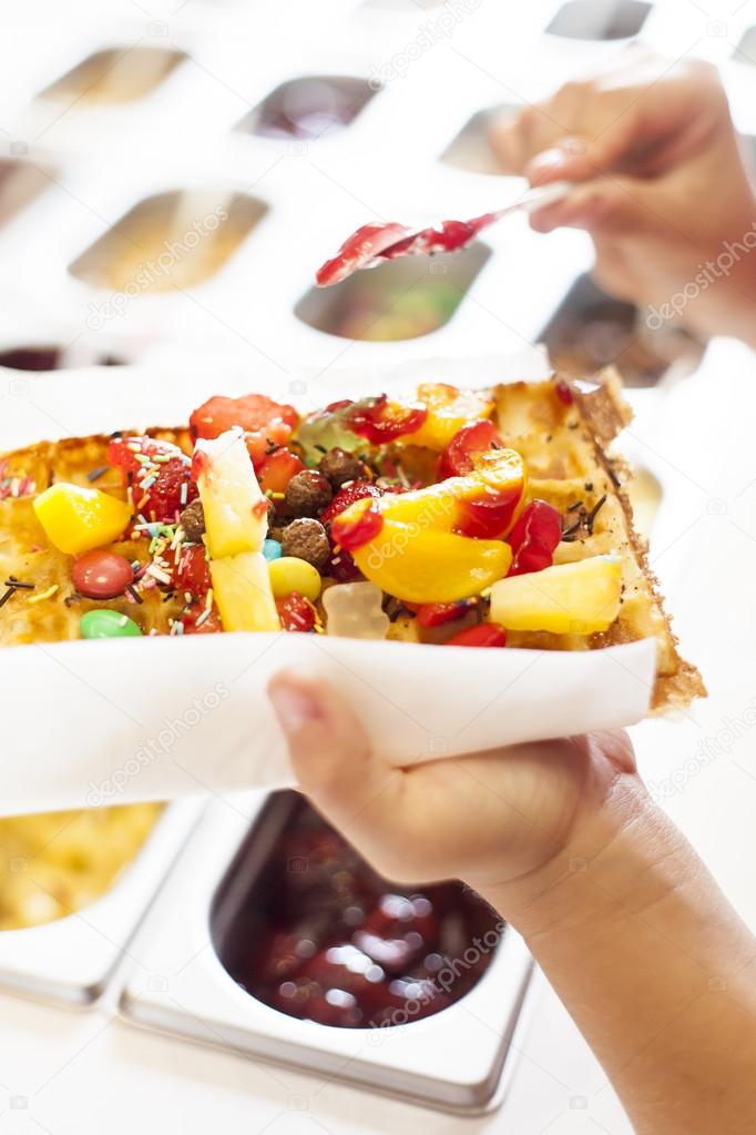 Waffle with fruit and candy.
