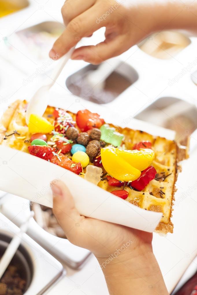 Waffle with fruit and candy.