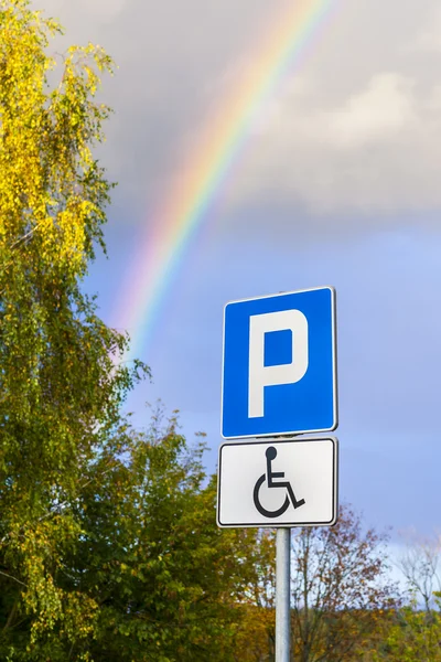 Rainbow over a parking space for the disabled person. — Stock Photo, Image