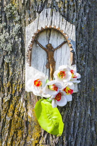 Langs de weg kapel met Jezus op een boom. — Stockfoto