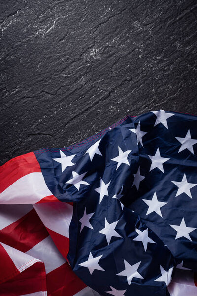 Concept of U.S Independence day or Memorial day. National flag over dark slate table background.