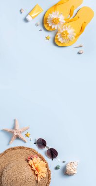 Yaz sahili tasarım konsepti. Deniz kabukları, şapka, mavi arka planda terlik ile tatil seyahatinin en üst görüntüsü.