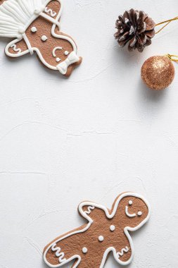 Süslü Noel kurabiyelerinin beyaz masa arkaplanında fotokopi alanı ve bayram kutlaması konseptiyle üst görünümü.