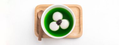 Matcha büyük tangyuan 'ın (tang yuan) beyaz masa arkasında tatlı kibrit çorbası ve kırmızı fasulye ezmesi ile festival yemeği için beyaz masa arkasında.