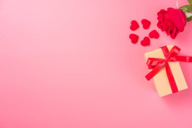 Kraft hediye kutusu içinde güzel kırmızı kurdele ve gül, Sevgililer Günü konsepti, yıldönümü, anneler günü ve doğum günü selamı, fotokopi alanı, üst manzara.