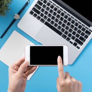 Ofis masası kavramını moda aksesuarlarına bağlayan sosyal ağ, akıllı telefon tutan bir kadınla minimum iç mekan, üst görünüm, düz mekan, taklit alanı