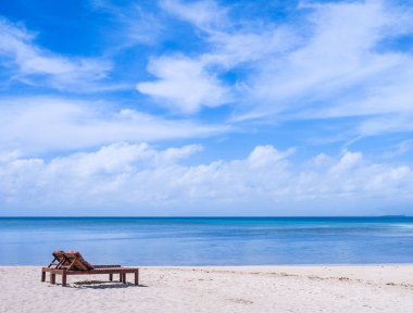 Mavi gökyüzü ile okyanusun yakınında muhteşem güzel kumlu plaj sandalyeler. Bir turizm fikri için yaz eğlence sakin tatil kavramı. Boş kopya alanı, tropikal peyzaj ilham