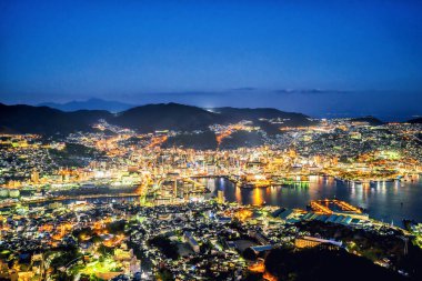 Business concept, modern cityscape of nagasaki dusk from mount inasa, the new top 3 nightview of the world, aerial view, copy space clipart