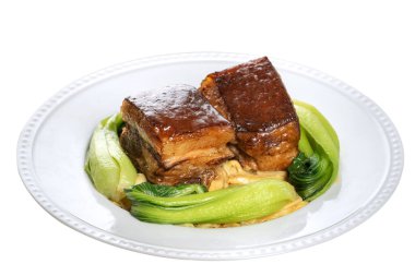 Dong Po Rou (Dongpo pork meat) in a plate with green vegetable isolated on white background, traditional festive food for Chinese new year cuisine meal.