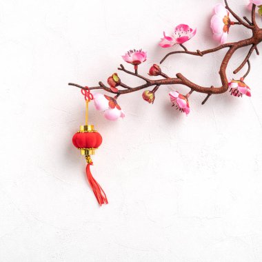 Top view of Chinese lunar new year background copy space design concept with pink plum blossom and festive decoration, the word inside picture means blessing.