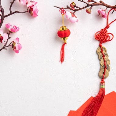 Top view of Chinese lunar new year background copy space design concept with pink plum blossom and festive decoration, the word inside picture means blessing.