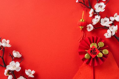Top view of Chinese lunar new year background copy space design concept with white plum blossom and festive decoration, the word inside picture means blessing.