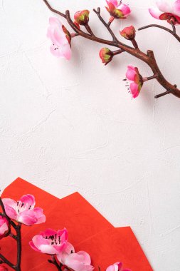 Top view of Chinese lunar new year background copy space design concept with pink plum blossom and festive decoration, the word inside picture means blessing.