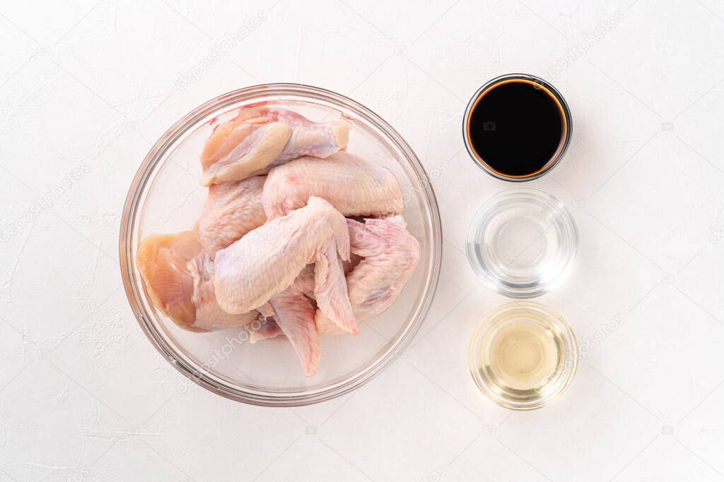 Cooking teriyaki sweet sauced chicken wings at home kitchen, recipe for Japanese style roasted food.