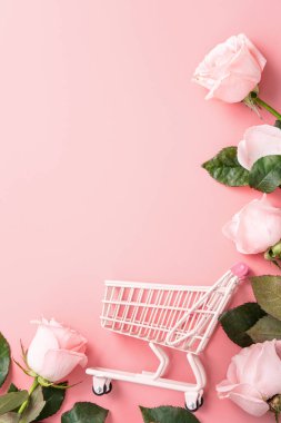 Anneler Günü alışveriş tasarımı konsepti pembe gül çiçeği ve el arabası arka planda.