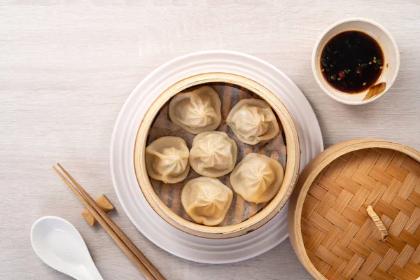 Eating steamed pork soup dumplings named Xiao long bao xiaolongbao in Taiwan, Taiwanese famous gourmet.