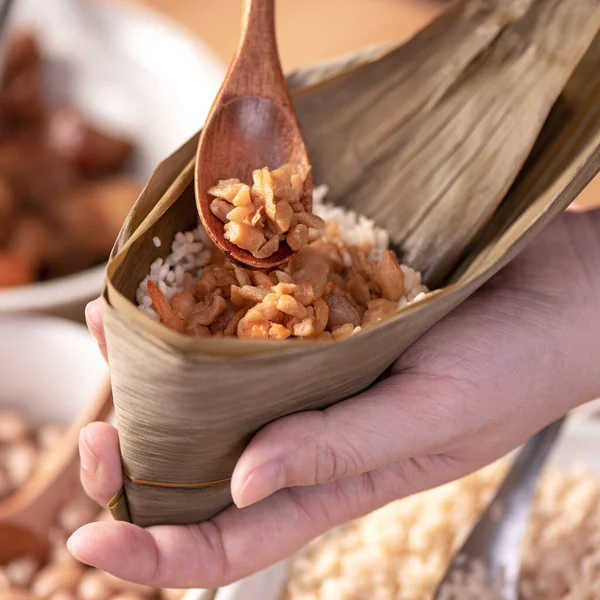 Making zongzi food - preparing and wrapping Chinese rice dumpling at home for Duanwu Dragon Boat Festival celebration, lifestyle.