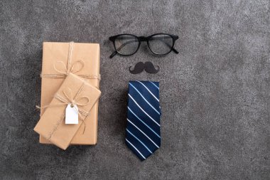 Babalar Günü arka plan tasarımı konsepti. Gri masa arkaplanında hediye kutusu olan kağıt dekorasyonu fikirlerinin üst görünümü.