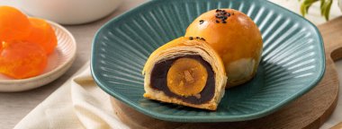 Design concept of Moon cake yolk pastry, mooncake for Mid-Autumn Festival holiday on wooden table background